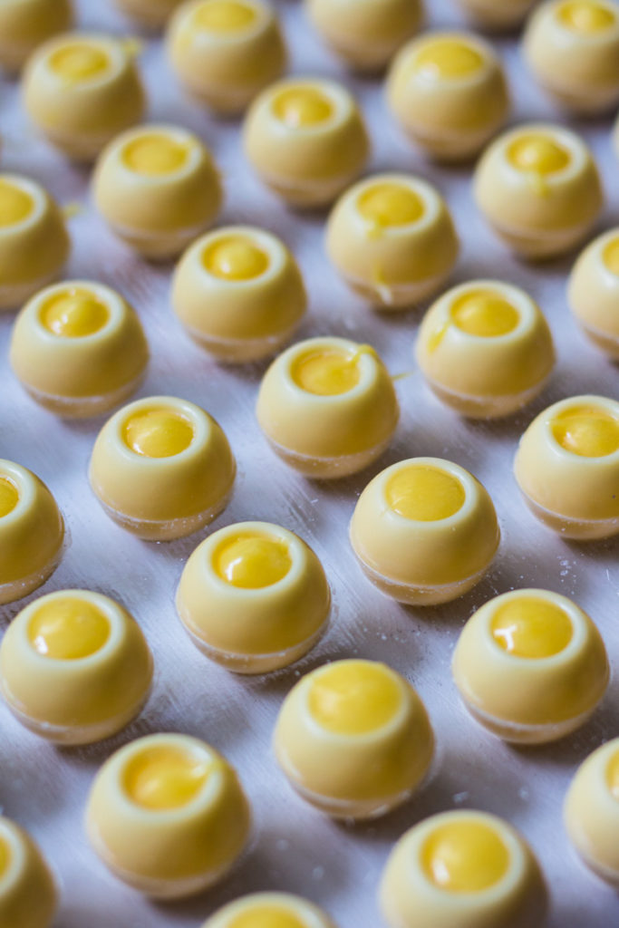 Pralinenhohlkörper gefüllt mit einer Ganache aus weißer Kuvertüre, Eierlikör und Passionsfrucht