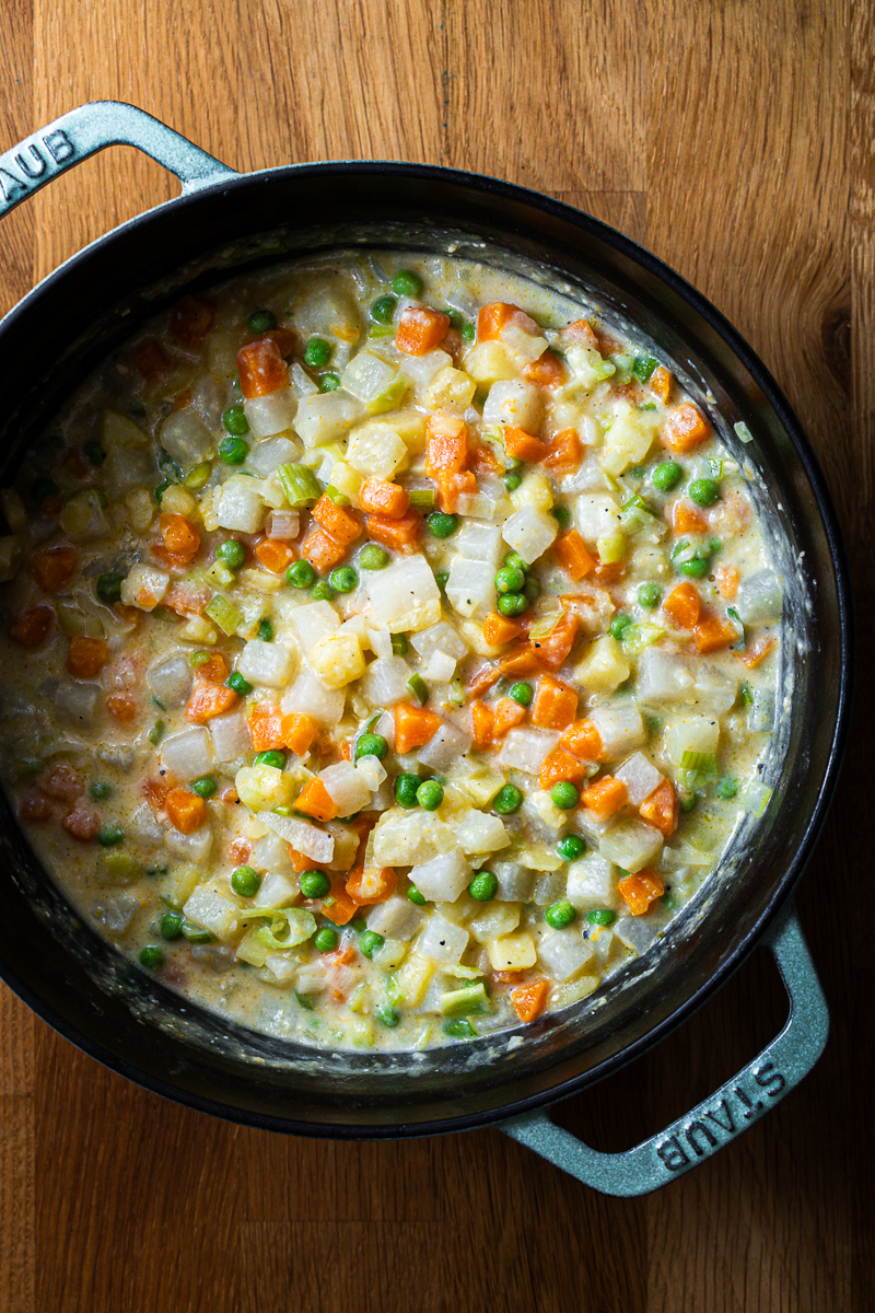 Cremiger Miso-Gemüseeintopf mit Kartoffeln, Kohlrabi, Möhren und Erbsen in einer STAUB Cocotte, von oben fotografiert